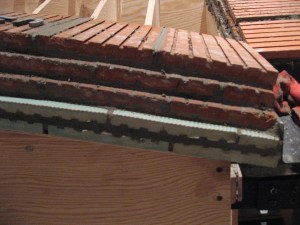 Close up of the five layers of tile. Two are ceramic, three are terracotta.