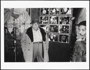 Mikey at the bar, next to my photographs. I loved hanging out, having a beer, taking pictures, listening to what people said about the neighbor-hood. People were open and generous with me, Mel Rosenthal, 1976-1982. Museum of the City of New York. 2013.12.14.