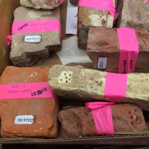 Bricks with drill holes removing sections for chemical analysis. Image courtesy of the author.