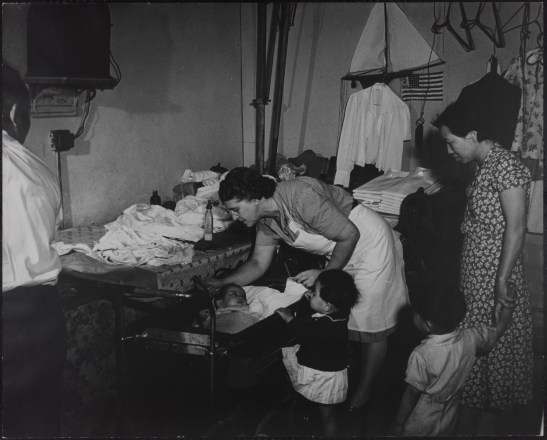 Henry Street Visiting Nurse Service, Checking the Ears of a Chin