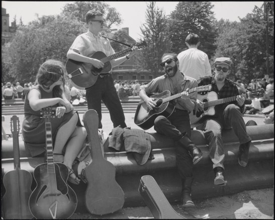 Bearded guitarist with other musicians, Washington Square Park
