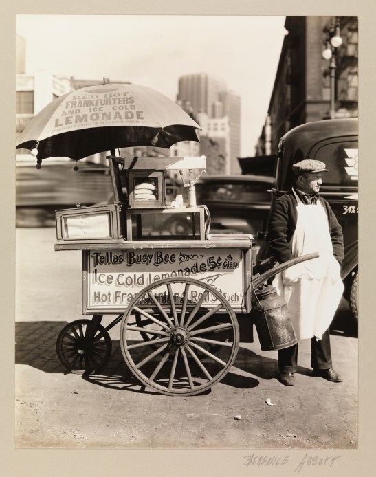 A street vendor selling hot dogs and lemonade at West and North Moore Streets.