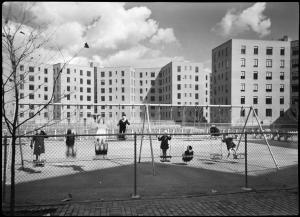 Wurts Bros. (New York, N.Y.), [Vernon Boulevard. Queensbridge Housing Project New York City Housing Project #N.Y. 5-2, exterior of first unit finished, proof size, children on swing.], 1939. Museum of the City of New York. X2010.7.1.16661