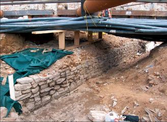 A segment of the Battery Wall exposed beneath modern utility lines during the South Ferry Terminal Project in 2005. This segment was nearly 40 feet long. Image from South Ferry Terminal Public Report, May 2011.