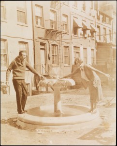 Unidentified man and Jessie Tarbox Beals. Edna St. Vincent Millay standing near fountain in Greenwich Village, ca. 1922. Museum of the City of New York, 94.104.862.