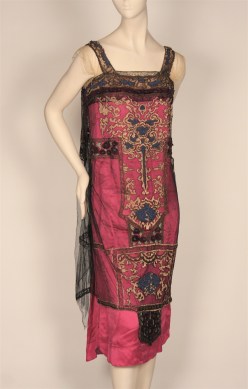 Evening dress in black net over magenta satin with gold metallic and chenille embroidery, ca 1920s. Museum of the City of New York, 79.15.7.